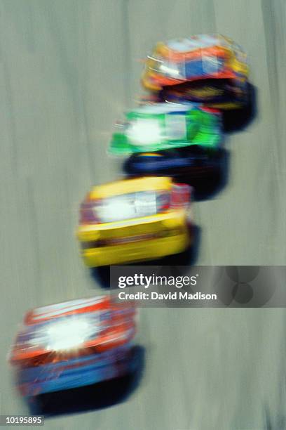 stock cars racing (blurred motion), overhead view - stock car racing stock-fotos und bilder
