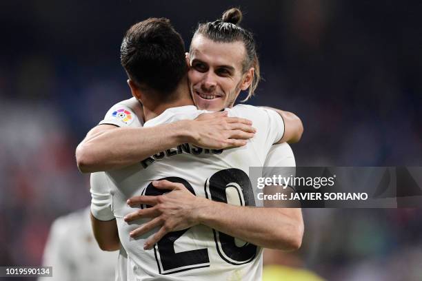 Real Madrid's Welsh forward Gareth Bale celebrates with Real Madrid's Spanish midfielder Marco Asensio after scoring a goal during the Spanish League...