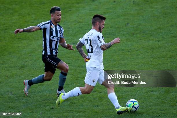 Leo Valencia of Botafogo struggles for the ball with Nathan of Atletico during a match between Botafogo and Atletico MG as part of Brasileirao Series...