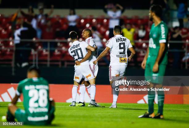 Shaylon of Sao Paulo celebrates with teammates after scoring the first goal of his team during the match against Chapecoense for the Brasileirao...