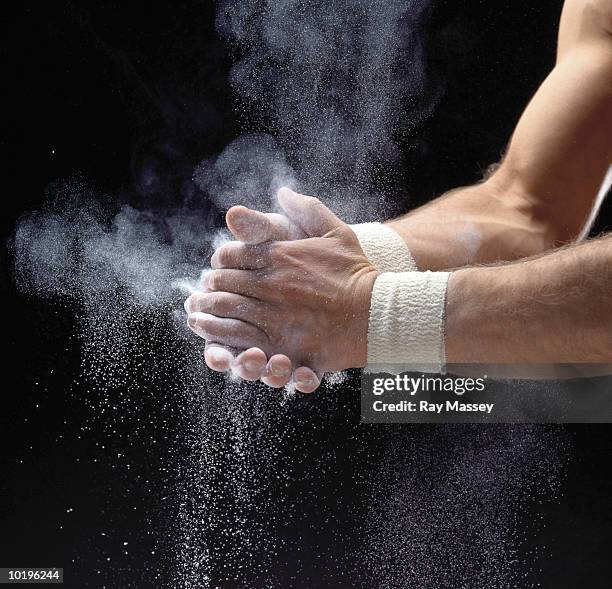 male gymnast powdering hands, close-up - giz equipamento esportivo - fotografias e filmes do acervo