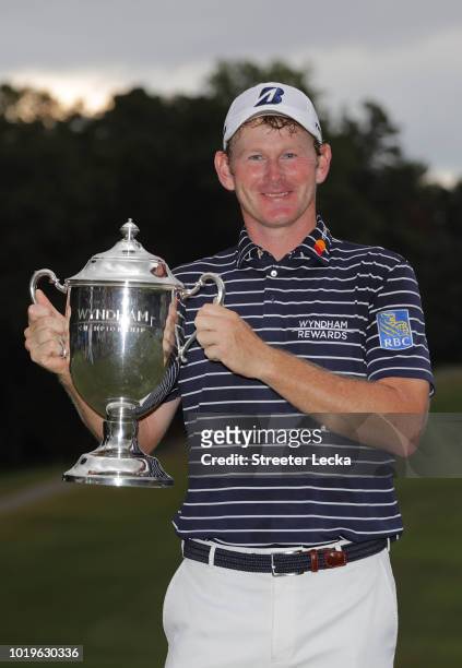 Brandt Snedeker poses with the trophy after winning the Wyndham Championship at Sedgefield Country Club on August 19, 2018 in Greensboro, North...