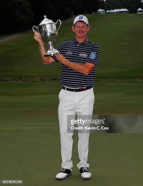 Brandt Snedeker poses with the trophy after winning the Wyndham Championship at Sedgefield Country Club on August 19, 2018 in Greensboro, North...