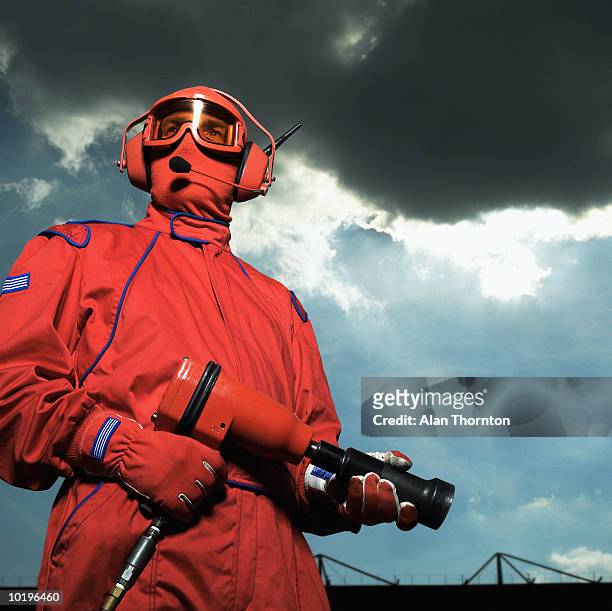 motor racing pit crew member holding airgun - pit stop stock pictures, royalty-free photos & images