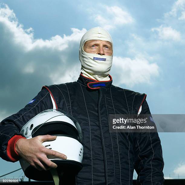 racing driver holding helmet, close-up - race driver stock-fotos und bilder