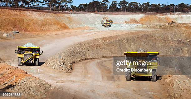Trucks carry nickel ore out of Western Areas NL's Tim King Pit open-cut nickel mine at Spotted Quoll, in Forrestania, Western Australia, on Thursday,...