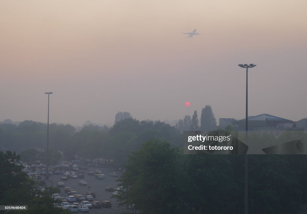City under smoky sky at Sunset due to BC forest wildfire, in Richmond BC Canada.