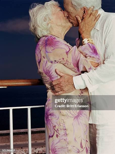 elderly couple on cruise ship, kissing, night - kissing mouth stock pictures, royalty-free photos & images
