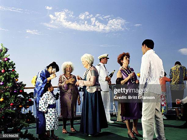 captain drinking with guests on deck of cruise ship - child standing talking stockfoto's en -beelden