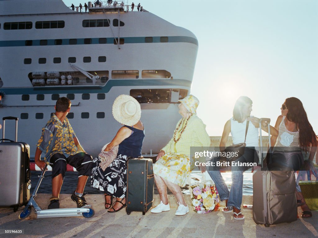 People with luggage waiting to board ship