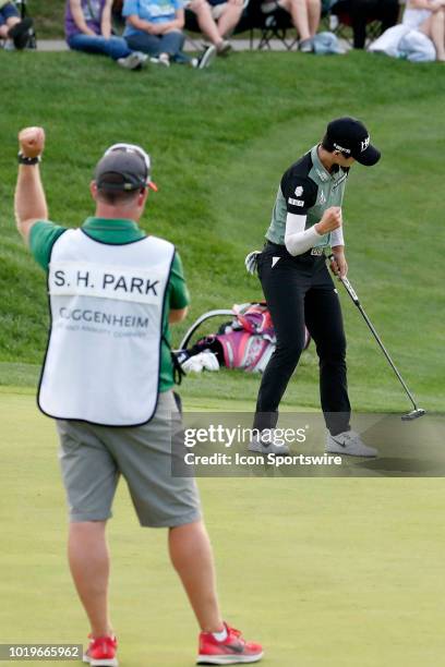 Golfer Sung Hyun Park and her caddie David Jones react as Sung Hyun Park makes a birdie putt on the 18th hole to win in a sudden death playoff during...