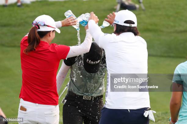 Golfer Sung Hyun Park has water poured on her by fellow players Jennifer Song in red and Amy Yang in white after she won on the 18th hole in a sudden...