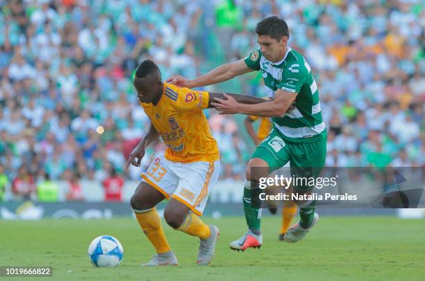 Julian Quinones of Tigres and Jesus Angulo of Santos fight for the ball during the fifth round match between Santos Laguna and Tigres UANL as part of...