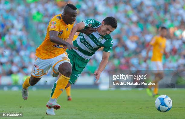 Julian Quinones of Tigres and Jesus Angulo of Santos fight for the ball during the fifth round match between Santos Laguna and Tigres UANL as part of...