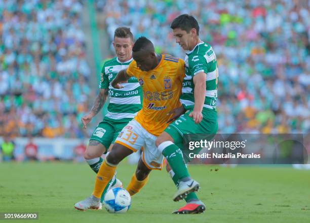 Julian Quinones of Tigres and Jesus Angulo of Santos fight for the ball during the fifth round match between Santos Laguna and Tigres UANL as part of...