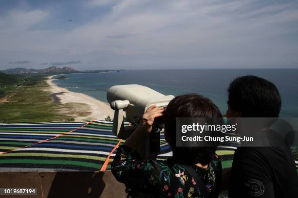 South Koreans use binoculars to look over the North Korea at the Unification observation on August 20, 2018 in Goseong, South Korea. Almost a hundred...