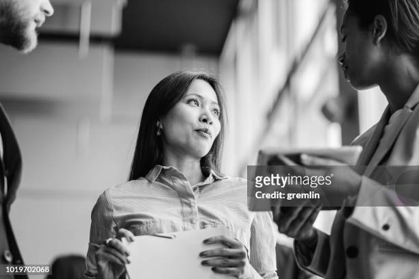 group of business people talking in the office - black and white stock pictures, royalty-free photos & images