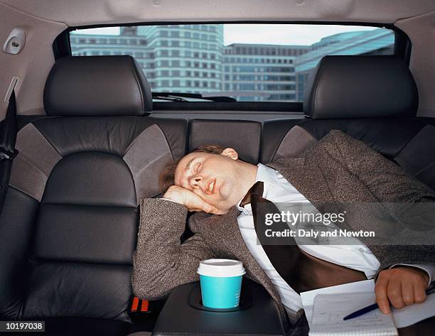 businessman sleping in car, close-up - sleeping in car foto e immagini stock