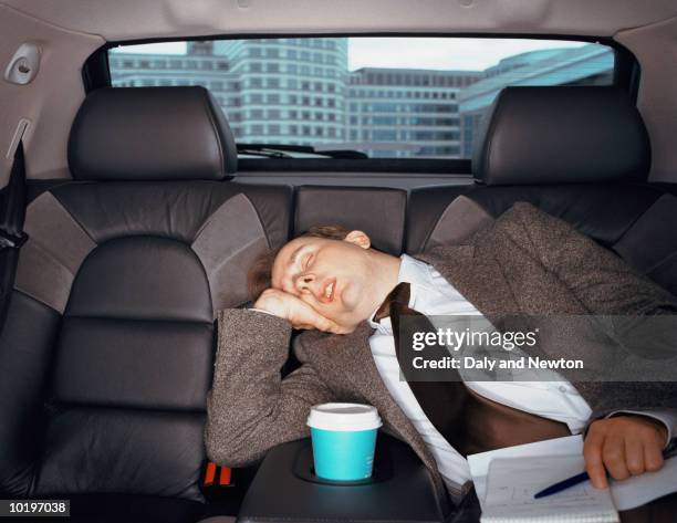 businessman sleping in car, close-up - sleeping in car stockfoto's en -beelden