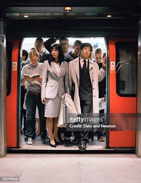 commuters exiting underground train - beengt stock-fotos und bilder