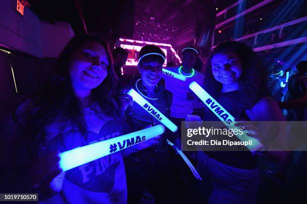 Fans pose with glowsticks during the MTV VMA Kickoff Concert presented by DirecTV Now at Terminal 5 on August 19, 2018 in New York City.