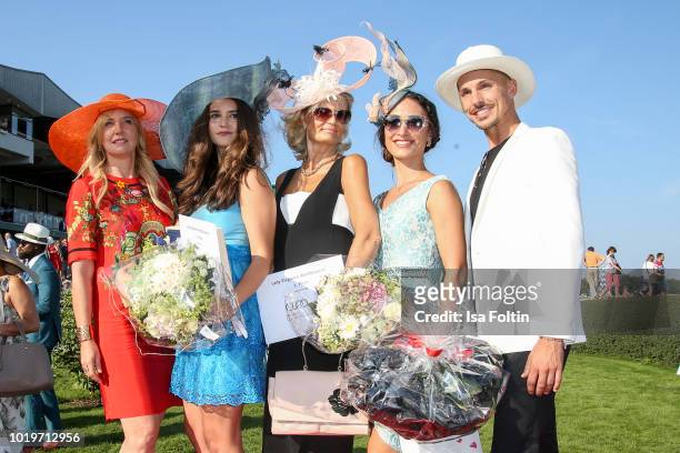 German presenter and dancer Oliver Tienken, Sylvie Hamacher and the winners of the hat competition during the Audi Ascot Race Day 2018 on August 19,...
