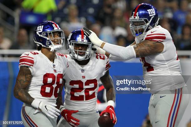 New York Giants running back Wayne Gallman is congratulated by New York Giants offensive tackle Ereck Flowers and New York Giants tight end Evan...