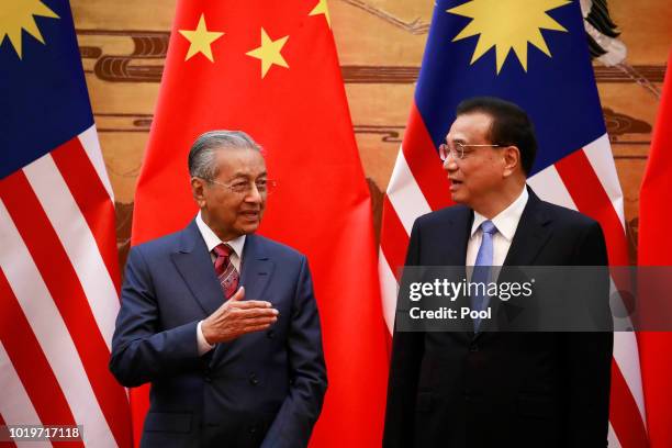 Malaysian Prime Minister Mahathir Mohamad and his Chinese counterpart Li Keqiang chat during a signing ceremony at the Great Hall of the People in...