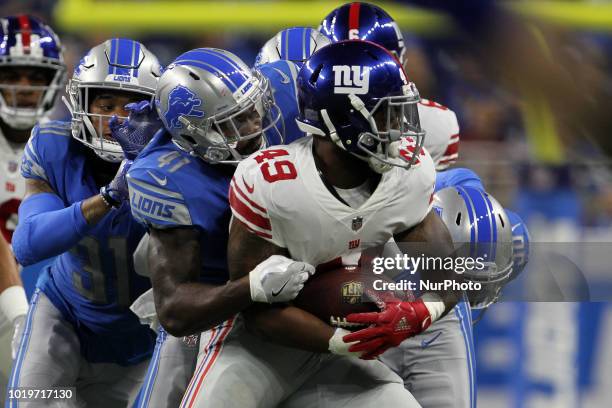 New York Giants running back Robert Martin runs the ball under the pressure of Detroit Lions defensive back Rolan Milligan and Detroit Lions...