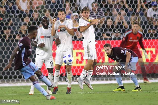 Kellyn Acosta of Colorado Rapids takes a free kick as the Los Angeles FC defend their goal at Banc of California Stadium on August 19, 2018 in Los...