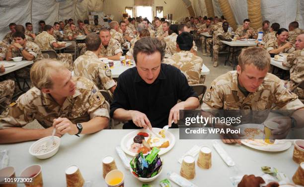 British Prime Minister David Cameron speaks to British troops at breakfast during his first visit to Afghanistan since taking office on June 11, 2010...