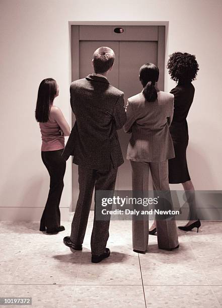 four business people waiting for lift, rear view - staring stock pictures, royalty-free photos & images
