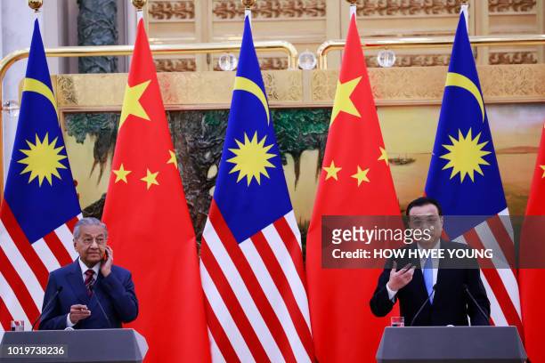 China's Premier Li Keqiang speaks during a joint press conference with Malaysia's Prime Minister Mahathir Mohamad at the Great Hall of the People in...