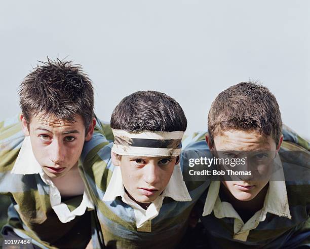 three boys (12-14) in scrum, portrait, close-up - kids rugby stock pictures, royalty-free photos & images