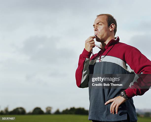 man blowing sports whistle - treinador desportivo imagens e fotografias de stock