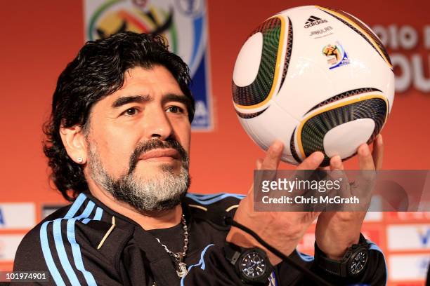 Argentina's head coach Diego Maradona holds up a match ball during a press conference at Loftus Oval on June 11, 2010 in Pretoria, South Africa.
