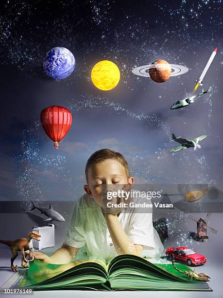child reading book with his imagination coming to  - child balloon studio photos et images de collection