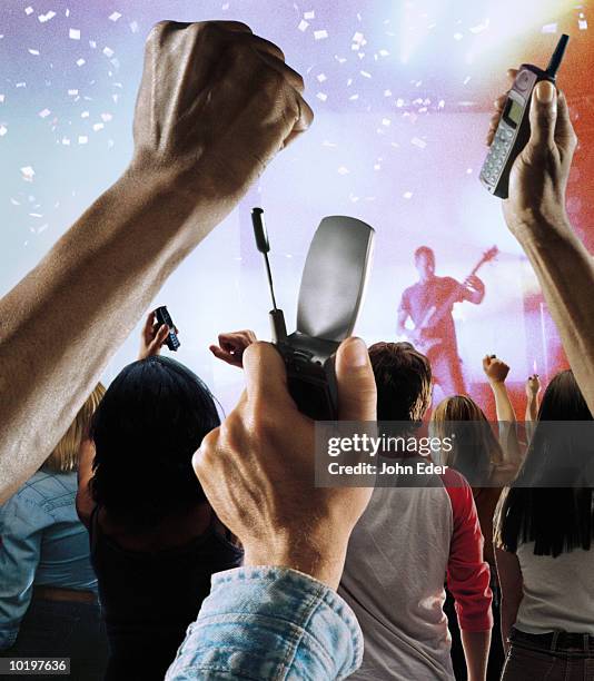 rock fans holding mobile phones in air during concert - many hands in air stock pictures, royalty-free photos & images