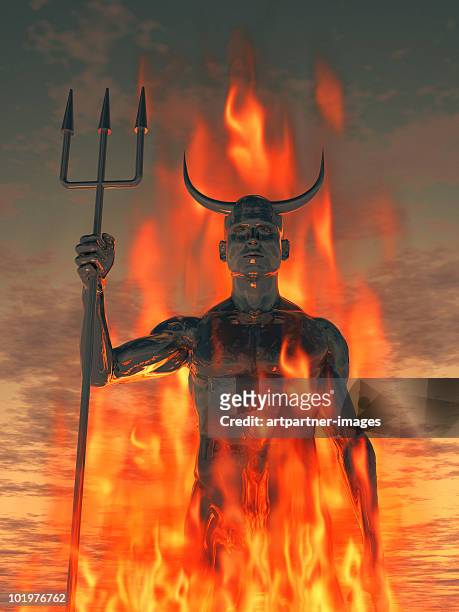 the devil /satan with trident in the fire - devil stock-fotos und bilder