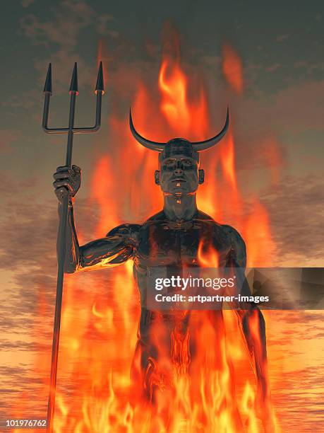 the devil /satan with trident in the fire - demon stockfoto's en -beelden