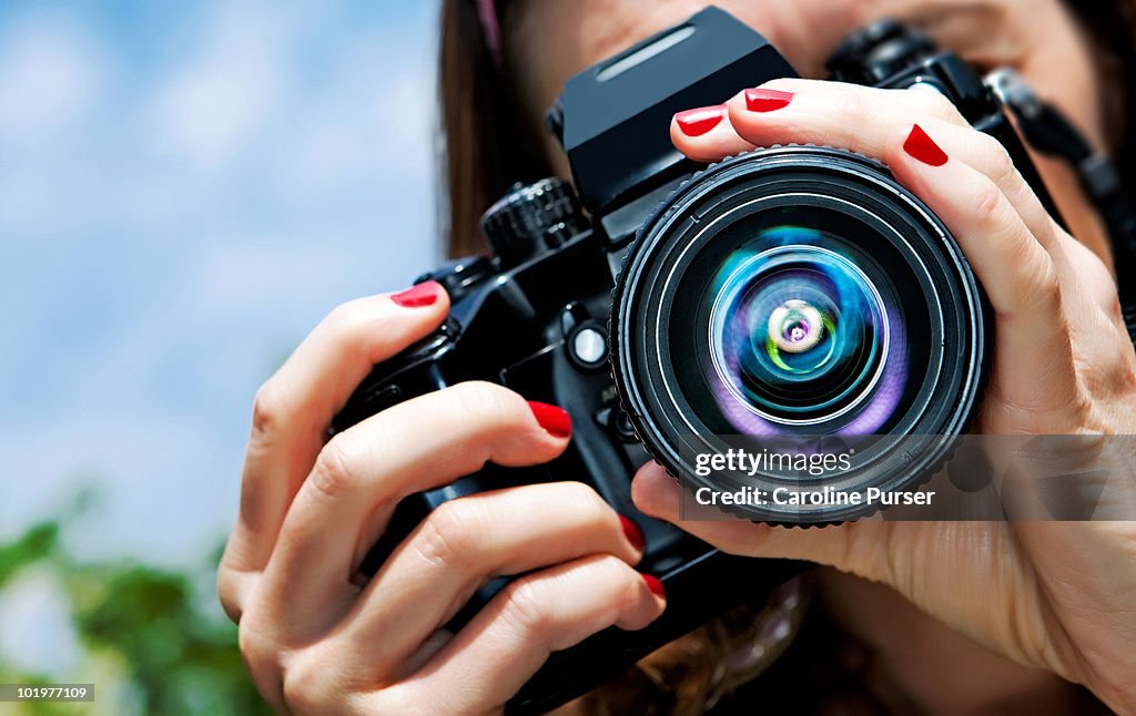 Close up of a girl taking a picture (to camera)