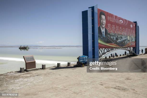 Billboard featuring Chinese President Xi Jinping and promoting China's production of magnesium, lithium and potassium stands in front of an...