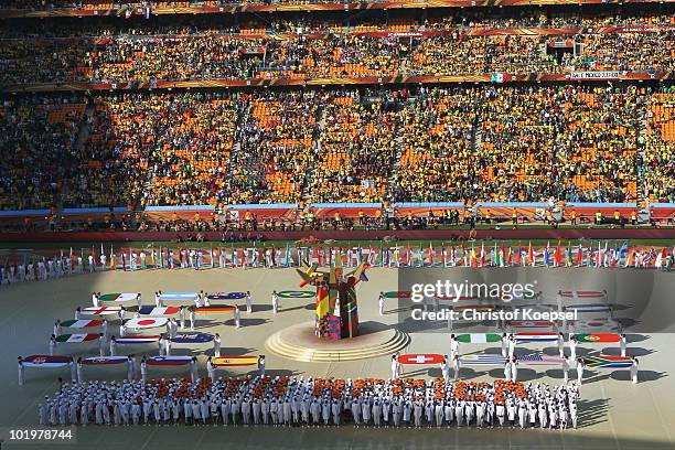 Performers display the flags of all the teams competing during the Opening Ceremony ahead of the 2010 FIFA World Cup South Africa Group A match...