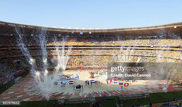 Performers display the flags of all the teams competing during the Opening Ceremony ahead of the 2010 FIFA World Cup South Africa Group A match...