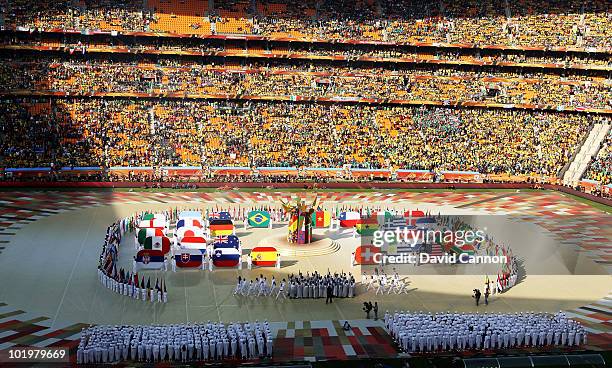 Performers display the flags of all the teams competing during the Opening Ceremony ahead of the 2010 FIFA World Cup South Africa Group A match...
