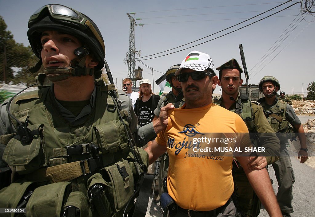 Israeli soldiers arrest a Palestinian pr