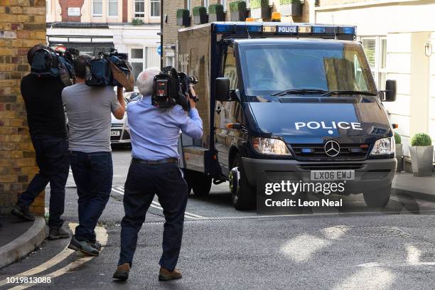 Members of the media film an armoured vehicle as it arrives at Westminster Magistrates court on the day that Salih Khater appears on attempted murder...