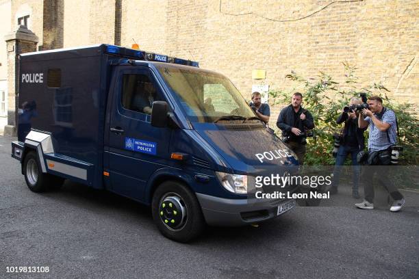 Members of the media film an armoured vehicle as it arrives at Westminster Magistrates court on the day that Salih Khater appears on attempted murder...
