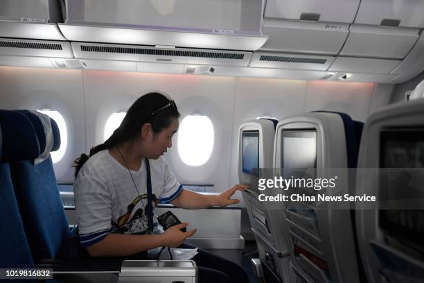 Passenger sits in Air China's first A350-900 aircraft at Chengdu Shuangliu International Airport on August 15, 2018 in Chengdu, Sichuan Province of...