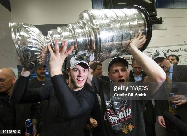 Jonathan Toews and Patrick Kane of the Chicago Blackhawks celebrate with the Stanley Cup in the locker room after defeating the Philadelphia Flyers...